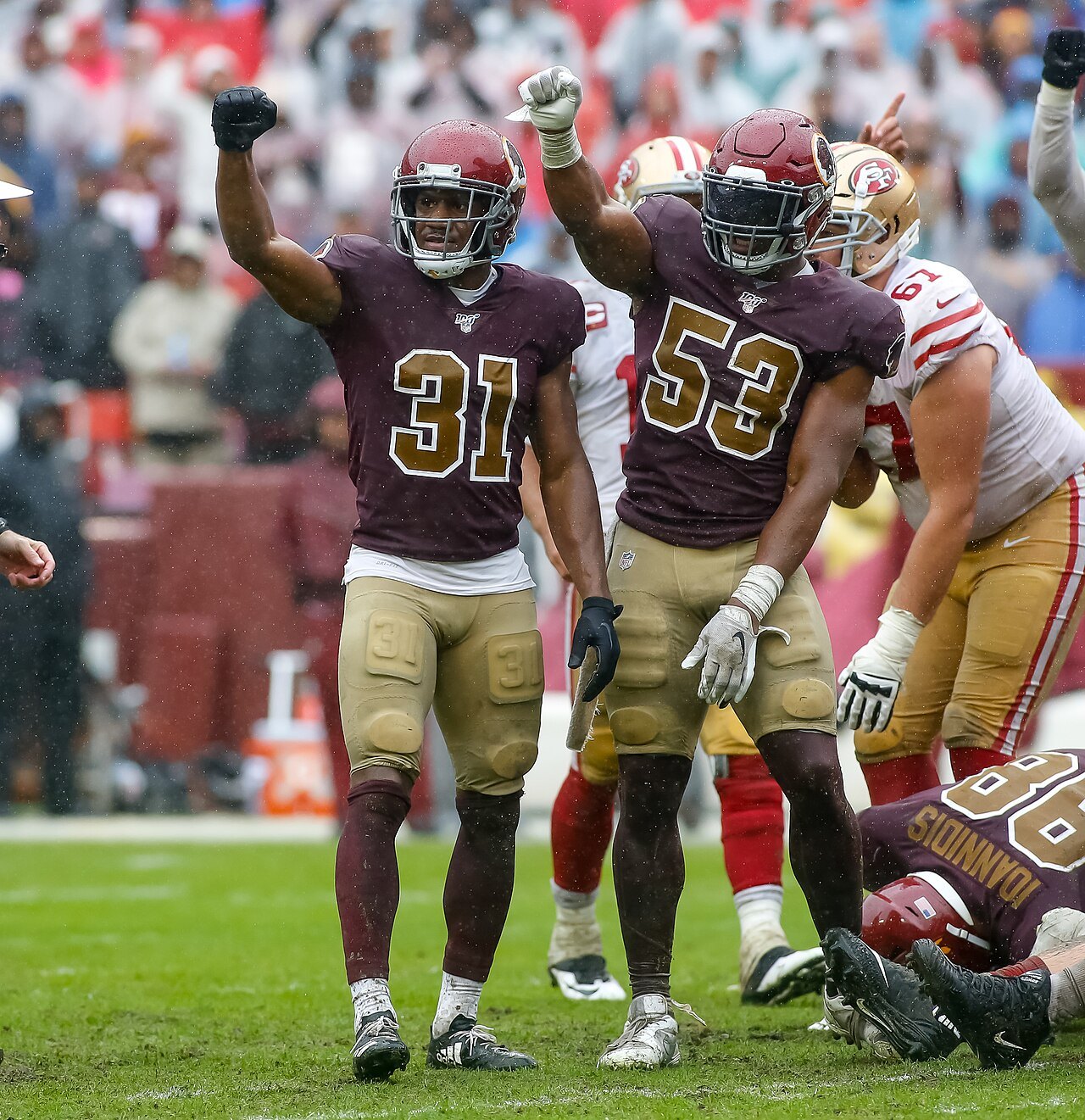 Washington defensive back Fabian Moreau and linebacker Jon Bostic raise their fists after a stop against the San Francisco 49ers, with 49ers offensive lineman Justin Skule behind them