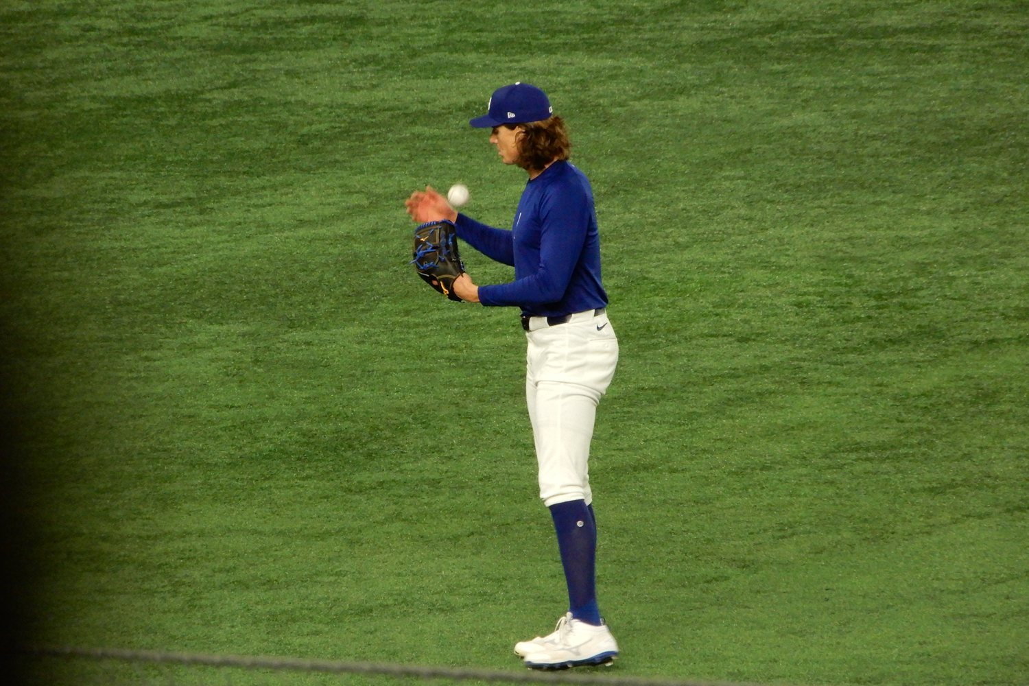 Los Angeles Dodgers starter Tyler Glasnow in a royal blue Dodgers top and cap, tossing a baseball into his glove on the field at Tokyo Dome, the right hander who starts NLDS Game 4 against the Braves