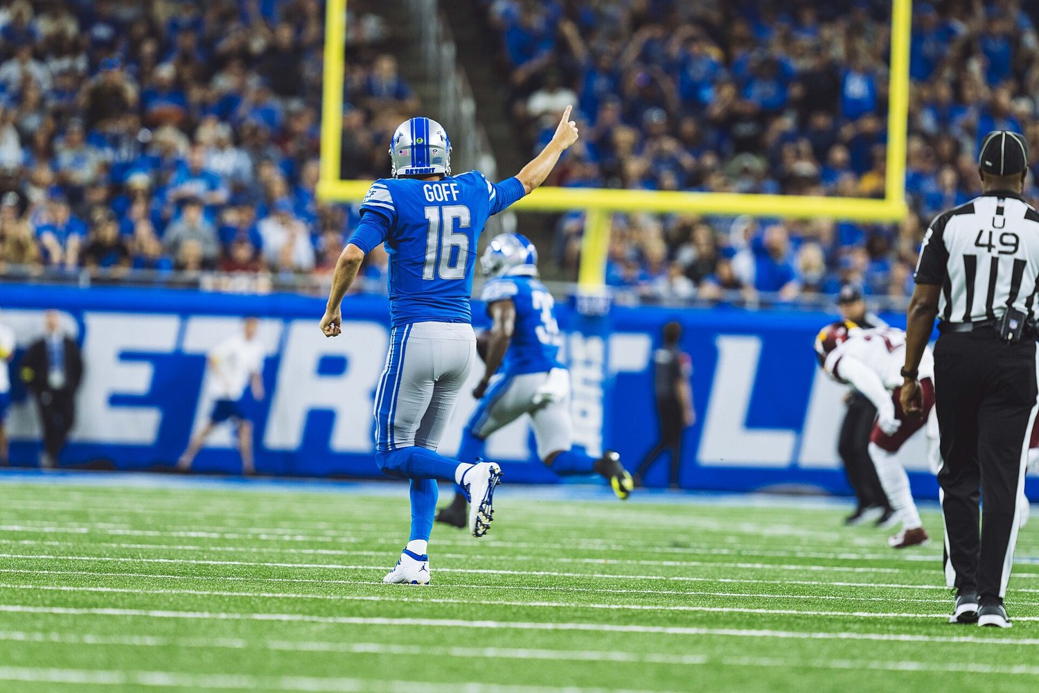 Detroit Lions quarterback Jared Goff, number 16 in the blue Lions home uniform, signaling first down at Ford Field, the quarterback who leads Detroit into Carolina on Sunday Night Football