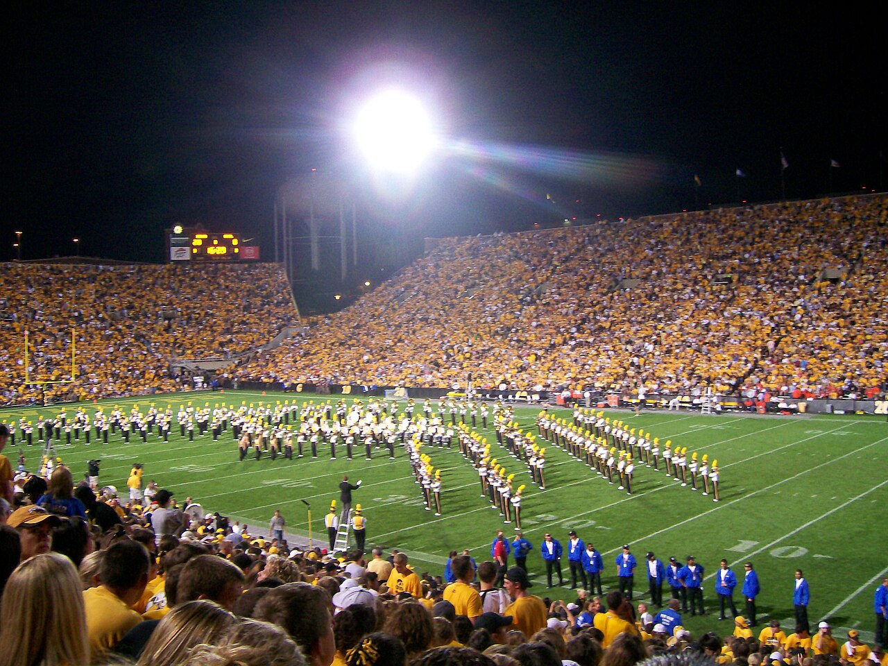 Kinnick Stadium in Iowa City at night with the Iowa marching band on the field