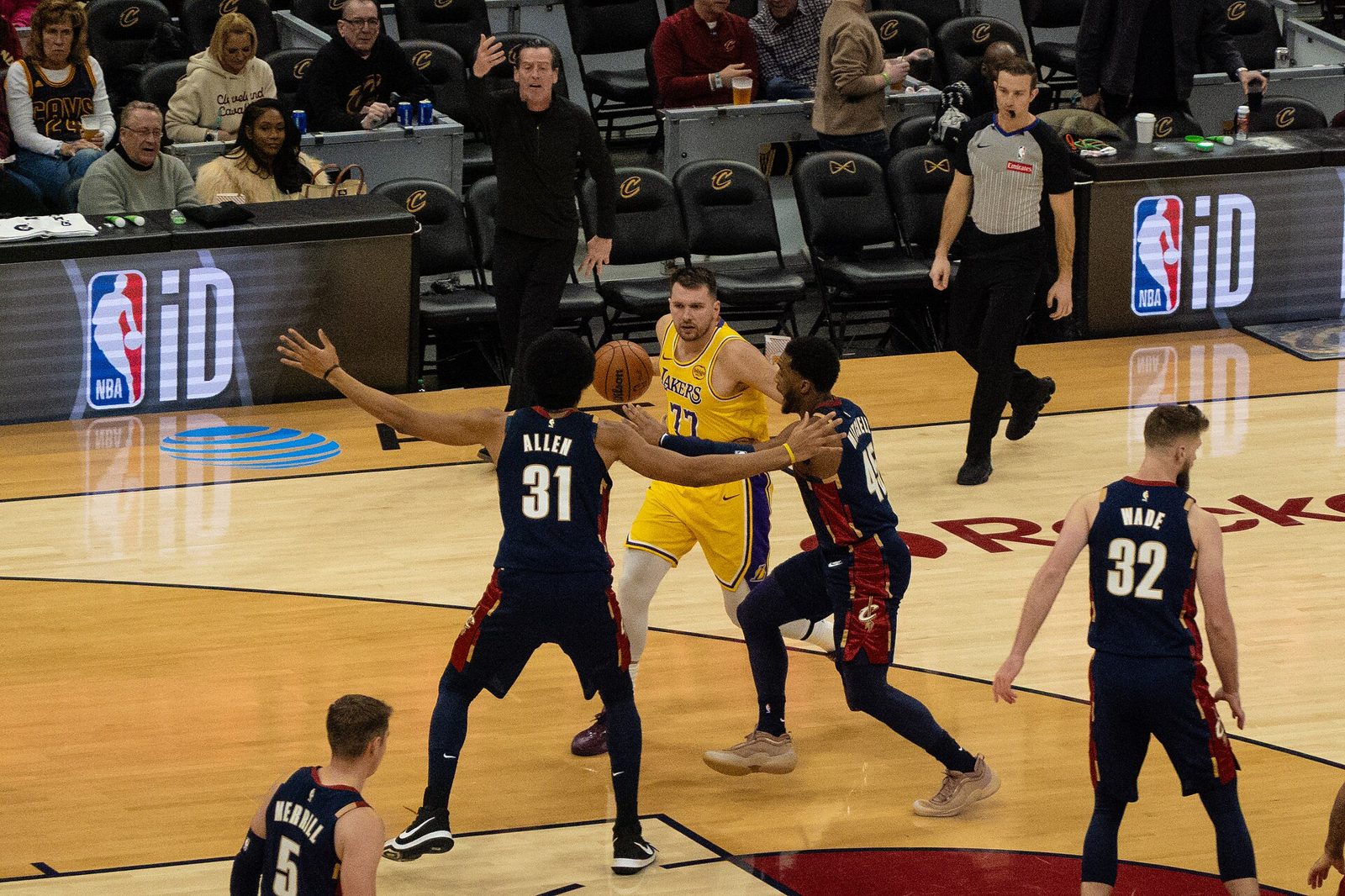 Los Angeles Lakers guard Luka Doncic handles the ball at the top of the floor while Cleveland's Jarrett Allen and Donovan Mitchell defend in January 2026