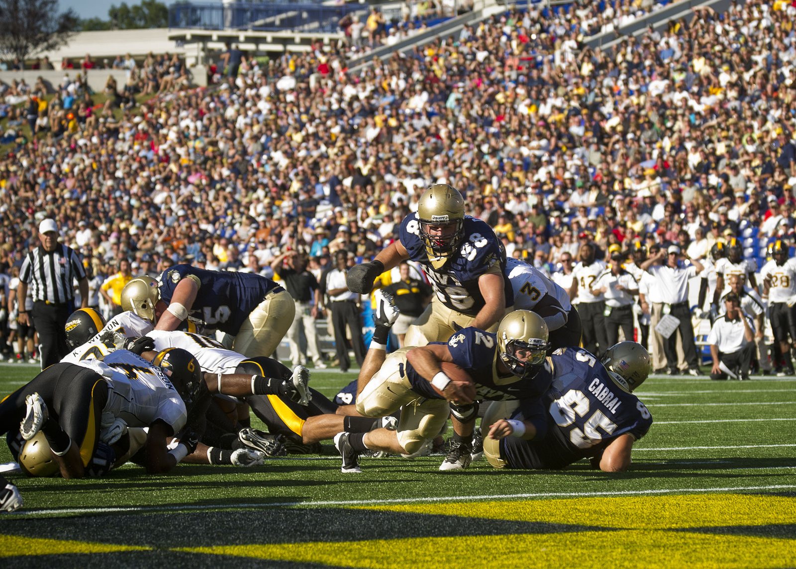 Navy quarterback Kriss Proctor diving for the goal line in a Navy home game